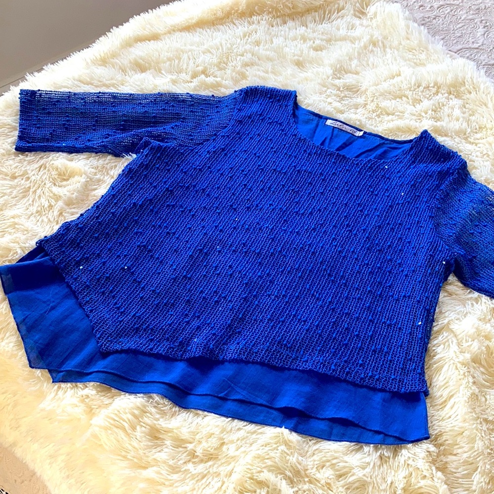 Sparkles on asymmetric hem with 3/4 sleeves.